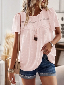 Detail of pink crew neck top featuring textured fabric and delicate lace patchwork