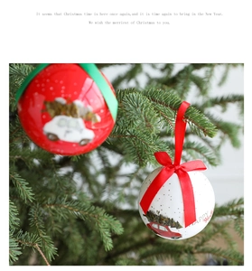 Close-up of white foam Christmas ball with red car illustration and festive ribbon