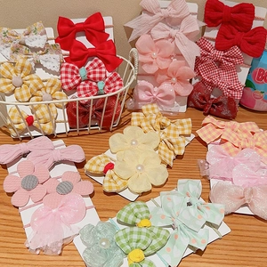 Kids hair accessories set featuring colorful bows and floral elastics on display cards