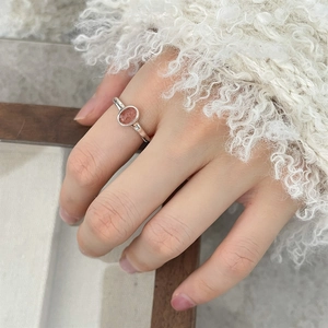 Elegant 925 sterling silver open ring with oval orange gemstone on a model hand