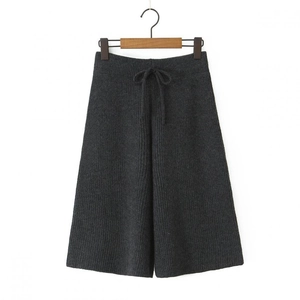Detail of dark grey knit wide-leg pants with high drawstring waist and vertical texture