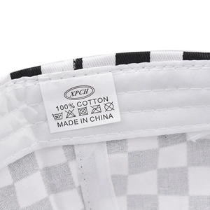 Detail view of cotton checkerboard baseball cap interior with wash label and stitching