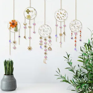 Set of 5 golden crystal suncatchers with dried flowers and celestial metal pendants