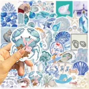 Close-up of a blue crab and bear sticker with a coastal cowgirl aesthetic theme