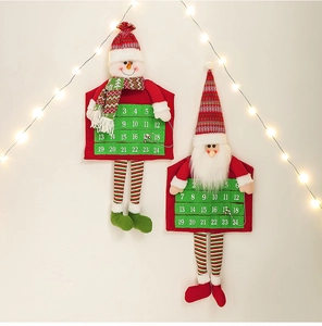 Christmas advent calendar with felt Santa and Snowman hanging on a wall with festive lights