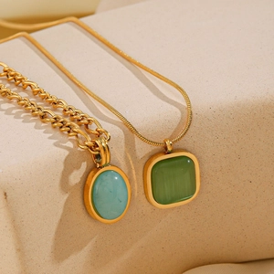 Detail of gold-plated stainless steel necklaces with green natural stone pendants