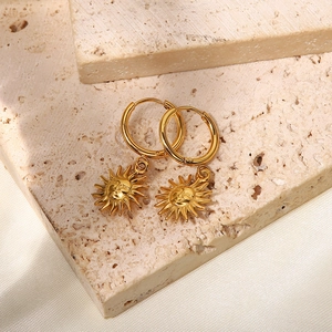 18K gold plated titanium steel hoop earrings with sun pendants on textured stone