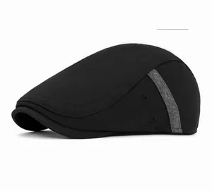Side view of black flat cap showing gray knit texture band and detailed cotton stitching