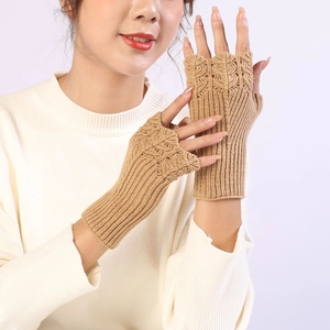 Macro detail of camel knit fingerless gloves showing scales pattern and ribbing texture