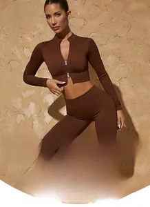 Detail of seamless chocolate brown yoga set with ribbed knit texture and half-zip crop top