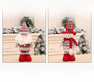Detail of Santa and Snowman plush dolls with red and grey plaid hats for Christmas decor