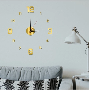 DIY golden mirror wall clock with numbers displayed in a modern living room setting