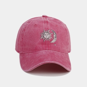Macro detail of sun and moon embroidery on retro washed cotton baseball cap