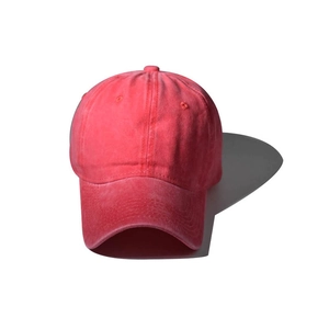 Detailed close-up of pink washed cotton baseball cap with vintage distressed texture