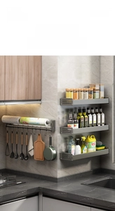 Detail of wall-mounted kitchen rack showing metal hooks and paper towel holder