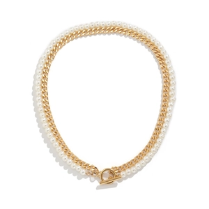 Detail of layered gold curb chain and faux pearl necklace with metallic OT toggle clasp