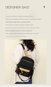 Detail of color-block nylon backpack with embroidery and brown leather handle on a white coat