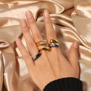 Polished gold and silver stainless steel stacked rings set with crystals on luxury silk