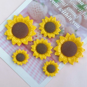 Detailed macro view of yellow resin sunflower DIY accessories in various sizes