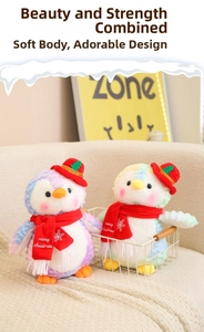 Detail of colorful tie-dye plush penguins wearing red Christmas hats and scarves