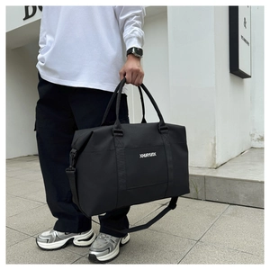 Outdoor model shot of a large black oxford sports travel bag with XHUAYUNX logo