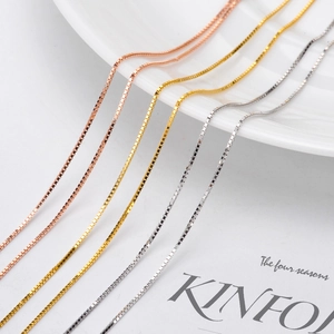 Three titanium steel extension chains in rose gold, gold, and silver finishes on a plate