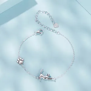 S925 sterling silver bracelet featuring a cute stretching cat and paw charm on blue surface