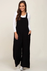Detail of black maternity wide-leg overalls with white long-sleeve ribbed knit shirt