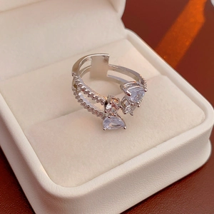 Close-up of a silver multi-layer ring with teardrop zircon in a premium gift box