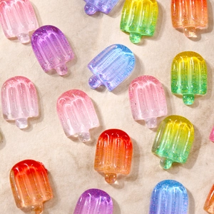 Macro view of colorful translucent resin ice cream charms for 3D nail art decoration