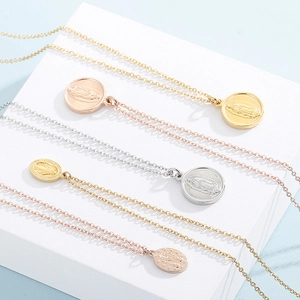 Detailed view of 18k gold plated Virgin Mary religious medal pendants in three colors