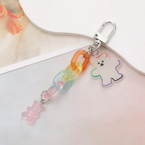 Close-up of pink gummy bear and acrylic bear charms on a colorful gradient chain