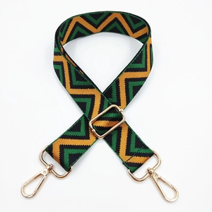 Detail of 3.8cm chevron wide bag strap with green, yellow, black stripes and gold hardware