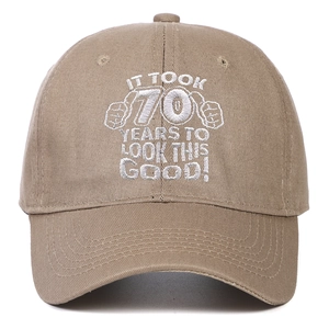 Close-up of khaki cotton baseball cap with 70th birthday embroidery on front