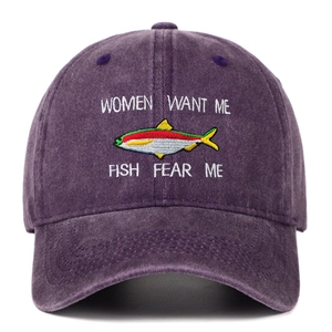 Detail of embroidered fish motif and funny text on purple washed cotton baseball cap