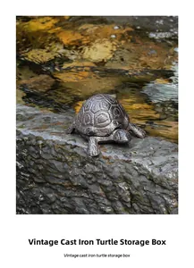 Detail of vintage cast iron turtle storage box on stones by a stream with natural water light