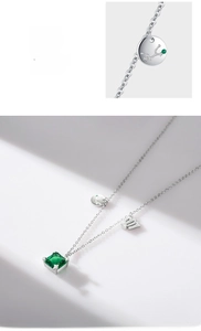 Macro detail of S925 silver Virgo necklace with emerald square stone and celestial charms