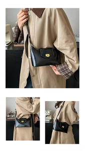 Chic black patent leather underarm bag featuring a gold metal buckle and adjustable strap