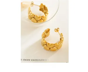 Detailed view of 18K gold-plated titanium steel earrings with linked heart motifs