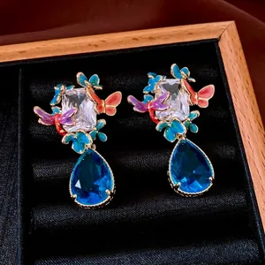 Vintage gold plated butterfly drop earrings with blue crystal pendant and zircon details