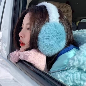 Fluffy blue faux rabbit fur earmuffs and pink plush gloves set for winter outdoor warmth