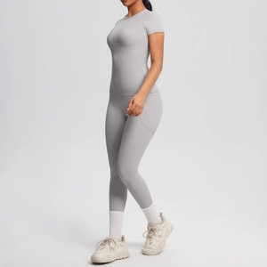 Slim fit light gray short sleeve top and high waisted leggings with side pockets
