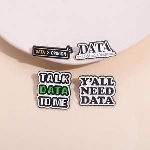 Minimalist enamel lapel pins featuring data-themed humor on white decorative pedestal