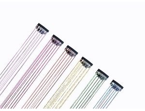 Close-up of colorful tinsel hair extensions with snap clips in six vibrant glitter shades