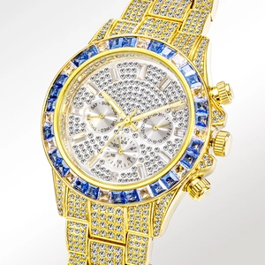 Luxury gold iced-out chronograph watch with blue sapphire bezel and crystal dial