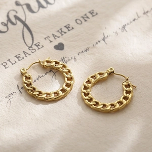 French vintage style golden Cuban chain hoop earrings made of titanium steel on paper