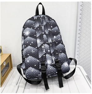 Detalle de mochila acolchada negra con texturas de patrones de corazones y estrellas brillantes