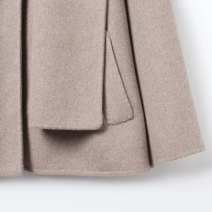 Elegant beige wool coat featuring detailed pocket flap and premium wool texture finish