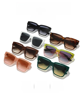 Flat lay of square oversized sunglasses in multiple colors showing frame details and lenses