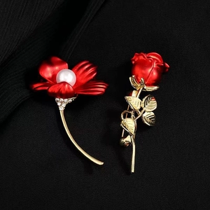 Elegant red flower brooch set with pearl center and vintage gold finish on black fabric